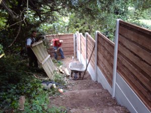 Installing heavy duty waney lap fence with concrete posts and gravel boards with 90 degree bend at bottom of the garden.