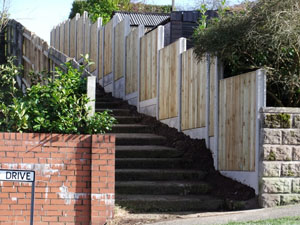 VCB fencing panel, with plain concrete bargeboards, finished installation.